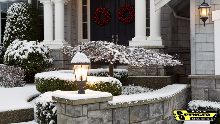 A stone front porch covered in snow