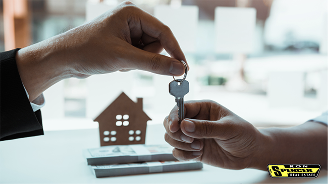 Agent handing over key